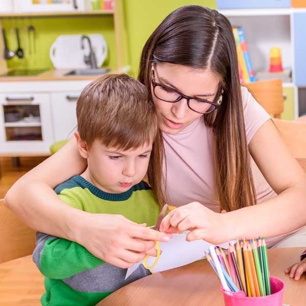 adult assisting a young boy