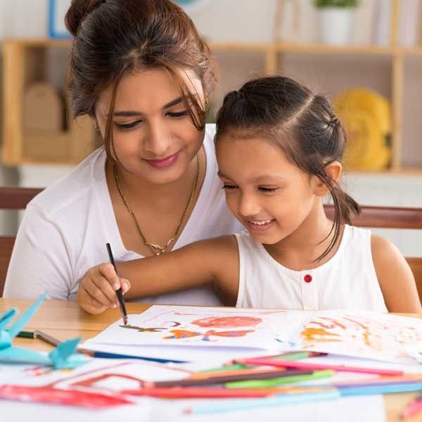 adult and child enjoying quality time with art supplies and paper