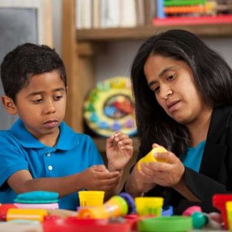 adult and child working with playdough